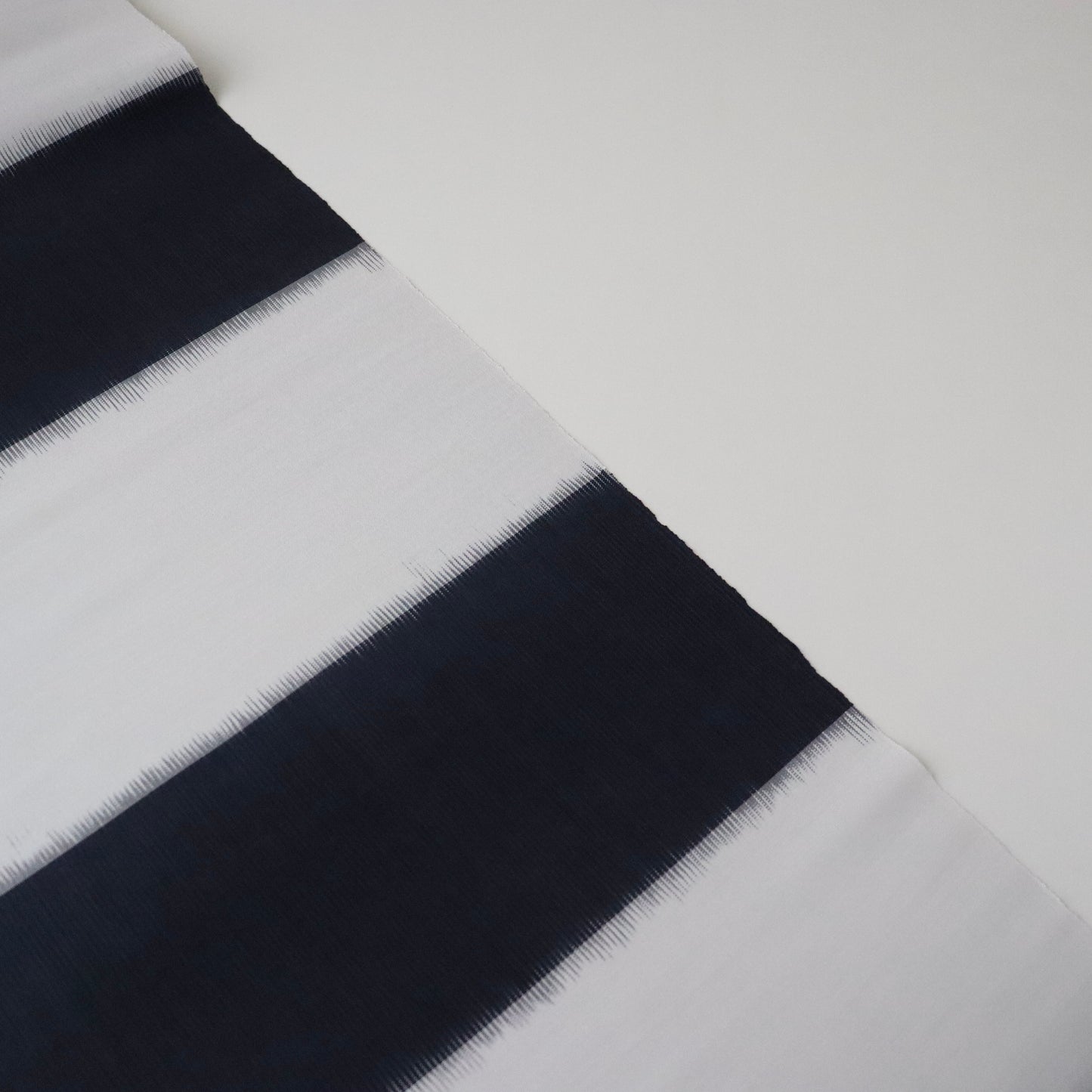 九寸名古屋帯「経浮絣花織 - 濃紺段 円」澤村佳世