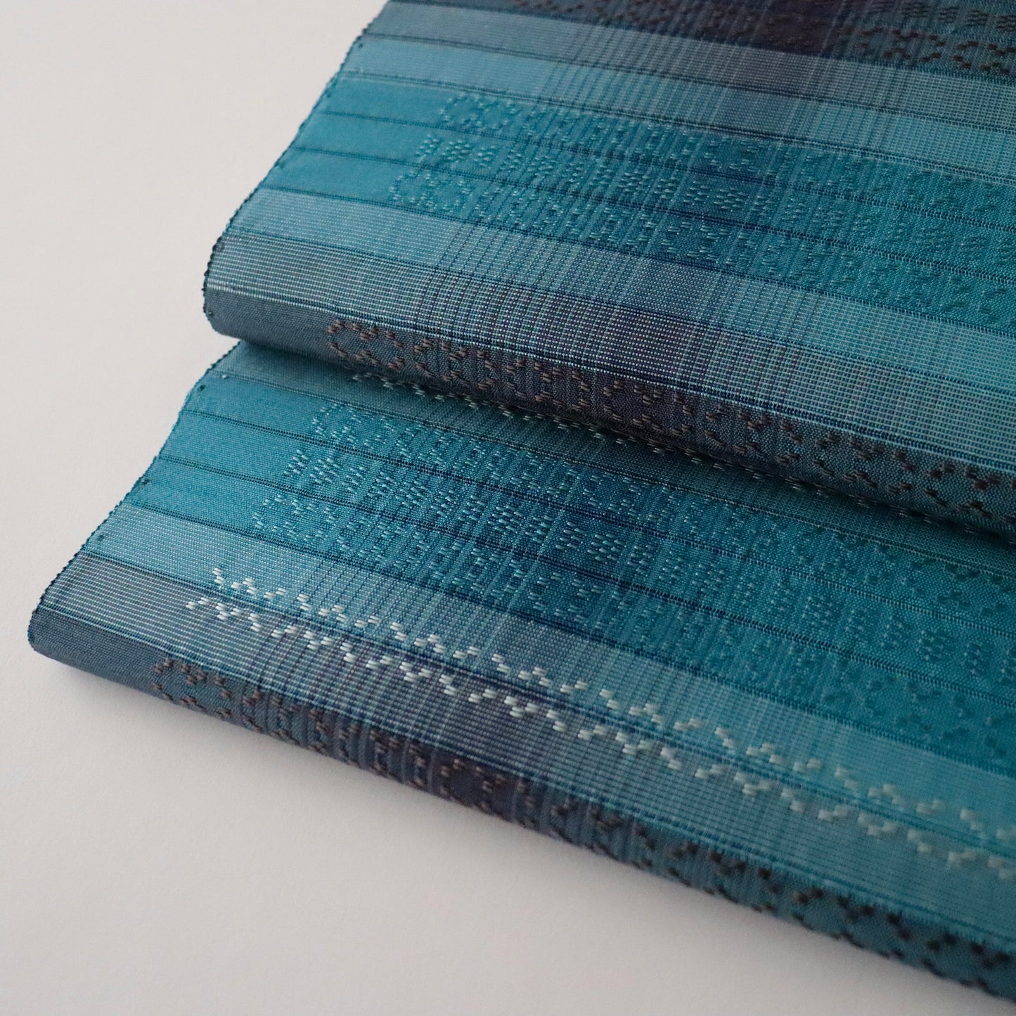 九寸名古屋帯「首里花倉織 - 碧縞」赤嶺真澄